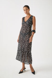 Lightweight dalmatian resort dress shown in motion with scalloped lace hem