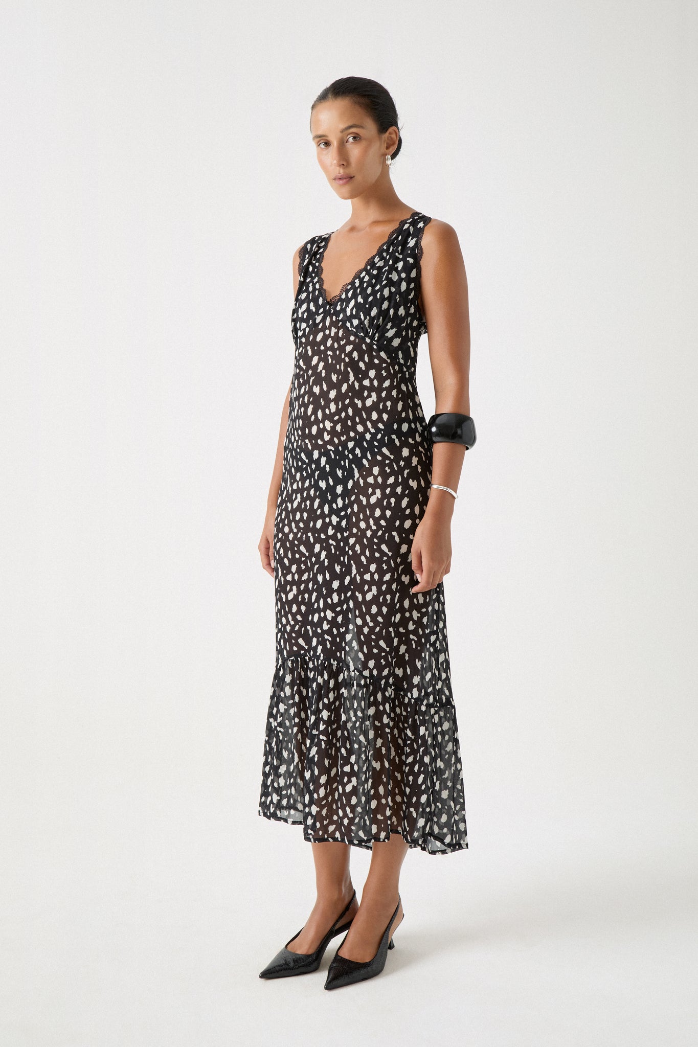 Model wears Unna Dress in dalmatian print with lace trim and relaxed drape