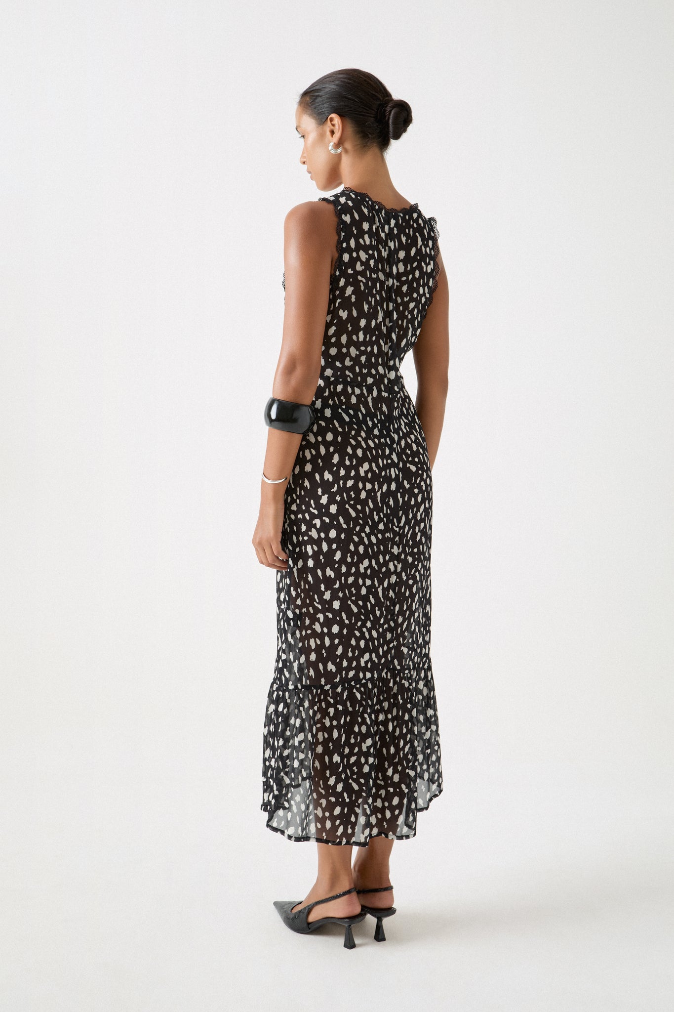 Dalmatian print dress with lace-trimmed back and fluid, full-length drape styled with slingbacks